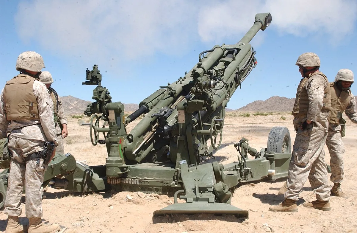 Artillery crew operating a towed howitzer